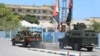 An armored personnel carrier drives near a hotel in Mogadishu on March 15, 2024. A siege at a popular hotel in the Somali capital killed three soldiers and ended early on March 15, 2024.