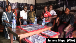 Eco Awad Roman (4th from L), who handed Pope Francis 100 SSP during his visit to Juba, sits with his mother Mary Matthew (first), grandmother (last) and members of the Catholic Church, at his home in Juba, South Sudan, Feb. 15, 2023 (VOA/Juliana Siapai)