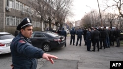 Armenian law enforcement officers stand outside a police station after an incident that the Caucasian country's government said was an attempt to seize the building in Yerevan, March 24, 2024. 