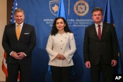 Kosovo's President Vjosa Osmani, center, meets with Special Representative to the Western Balkans, Gabriel Escobar, left, and EU Special Representative Miroslav Lajcak in Pristina, Kosovo, June 6, 2023. (Kosovo Presidency via AP)