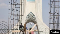 Iranian workers toil during the heat surge in Tehran, Iran, on July 21, 2024. (West Asia News Agency via Reuters)