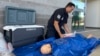 Phoenix Fire Capt. John Prato demonstrates a new heatstroke protocol that the fire department is adopting, in Phoenix, June 3, 2024.