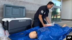 Phoenix Fire Capt. John Prato demonstrates a new heatstroke protocol that the fire department is adopting, in Phoenix, June 3, 2024.