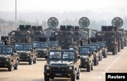 FILE - Military personnel participates in a parade on Armed Forces Day in Naypyitaw, Myanmar, March 27, 2021.