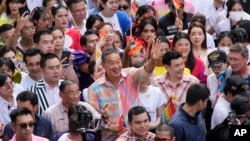 Thailand's Prime Minister Srettha Thavisin, center, raises his hand during the Pride Parade in Bangkok, Thailand, June 1, 2024.