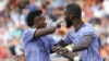 Real Madrid's Vinicius Junior, left, confronts Valencia fans as Antonio Rudiger tries to calm him down during a Spanish La Liga soccer match between Valencia and Real Madrid, at the Mestalla stadium in Valencia, Spain, May 21, 2023. 