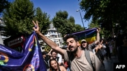 A demonstrator gestures as he holds a flag during the LGBT Pride Parade in the Kadikoy district to celebrate the Pride Month in Istanbul, June 30, 2024. Turkish police detained at least 15 protesters in Istanbul on Sunday for participating in the rally.