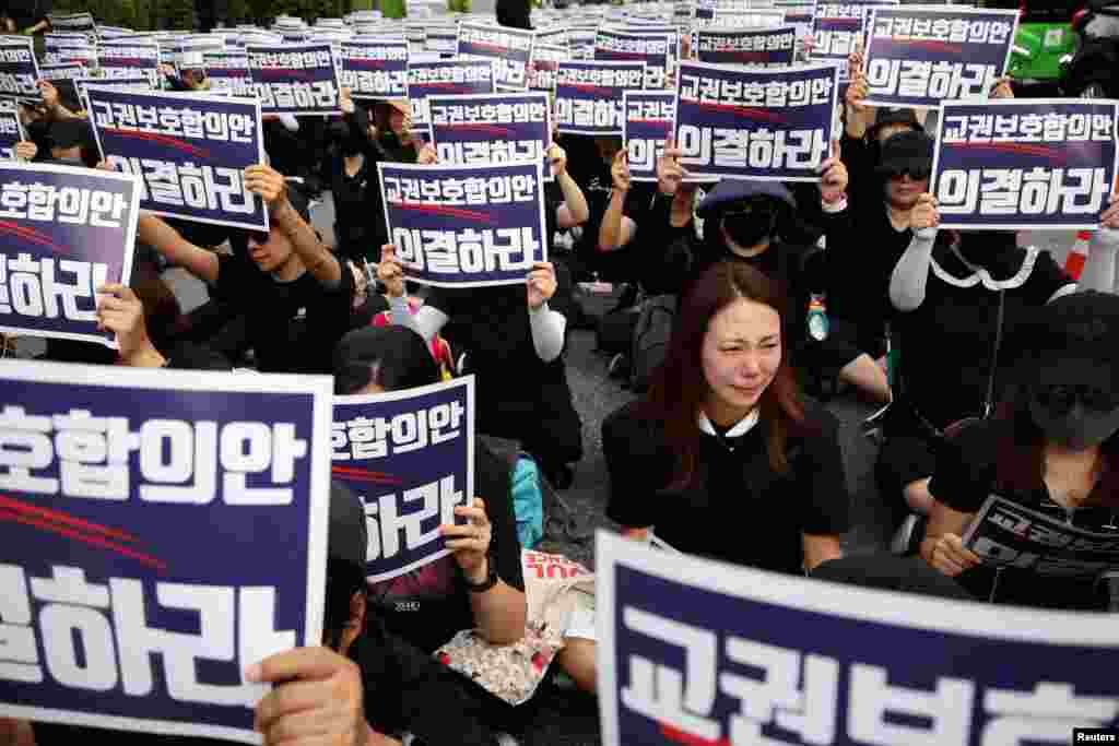 A South Korean teacher reacts during a protest to demand better protection of their rights, the normalization of public education and to mourn a young teacher found dead in July in an apparent suicide, in Seoul.