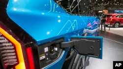The charging port of an electric battery-powered Kia EV9 Sport Utility Vehicle, which carries seven people and is marketed to millennial car buyers, is pictured at the New York International Auto Show, April 6, 2023.