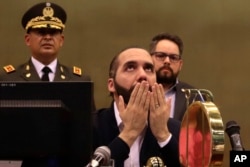 FILE - El Salvador's President Nayib Bukele offers a prayer in Congress, in San Salvador, El Salvador, Feb. 9, 2020.