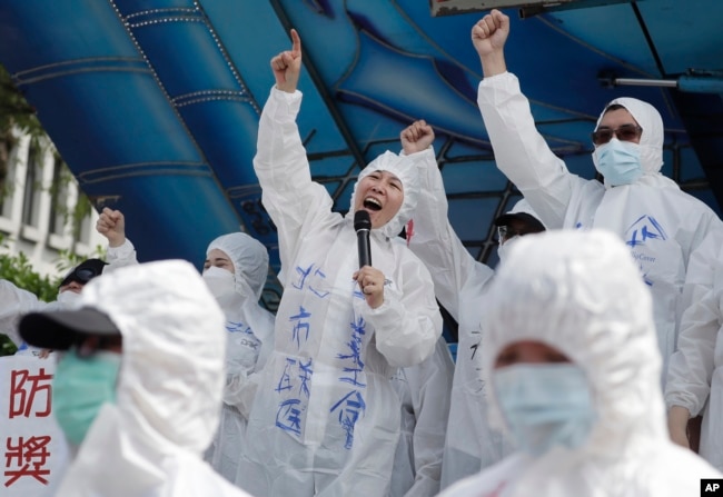 FILE - Medical workers protest to ask for increasing labor welfare during a May Day rally in Taipei, Taiwan, May 1, 2023. The term 山道猴子 (shan dao hou zi), "mountain roadmonkey," became popular for young people facing economic pressures. (AP Photo/Chiang Ying-ying)