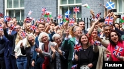 Supporters greet British Prime Minister Keir Starmer and his wife, Victoria Starmer, at Downing Street, following the results of the election, in London, July 5, 2024.
