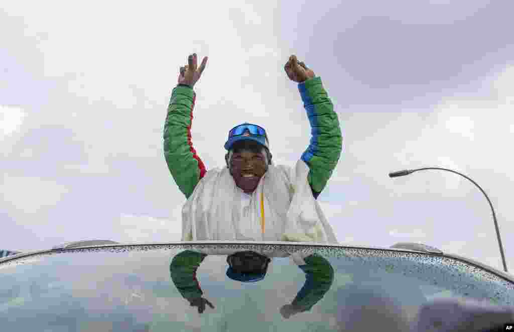 Renowned Sherpa mountain guide Kami Rita, returning from Mount Everest after his record 30th successful ascent, waves after he arrives at the airport in Kathmandu, Nepal.