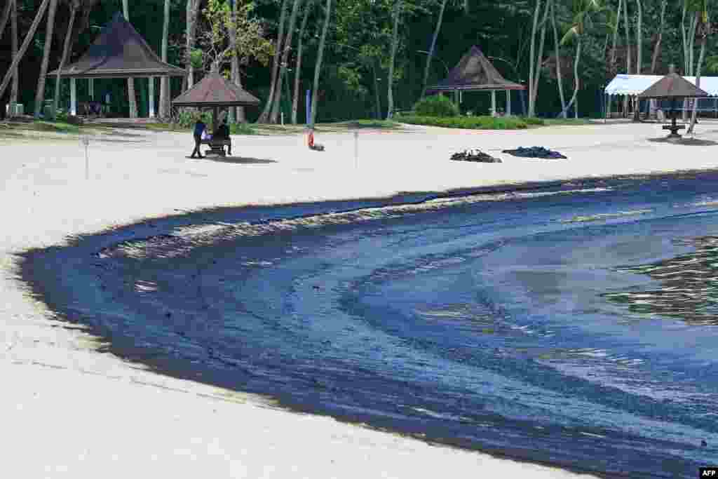 The oil slick is seen washed up on Sentosa island&#39;s Tanjong Beach in Singapore.