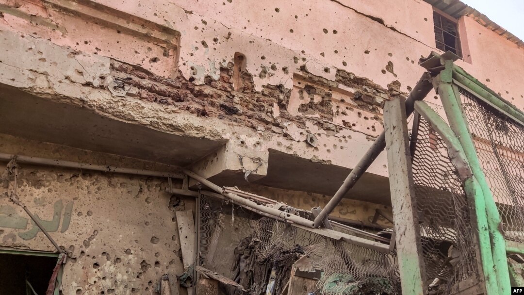 Bullet holes riddle the wall of a building at the Souk Sitta (Market Six) in the south of Khartoum on June 1, 2023. 