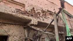 Bullet holes riddle the wall of a building at the Souk Sitta (Market Six) in the south of Khartoum on June 1, 2023. 