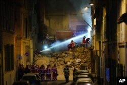 Firefighters work after building collapsed, April 9, 2023 in Marseille, southern France.