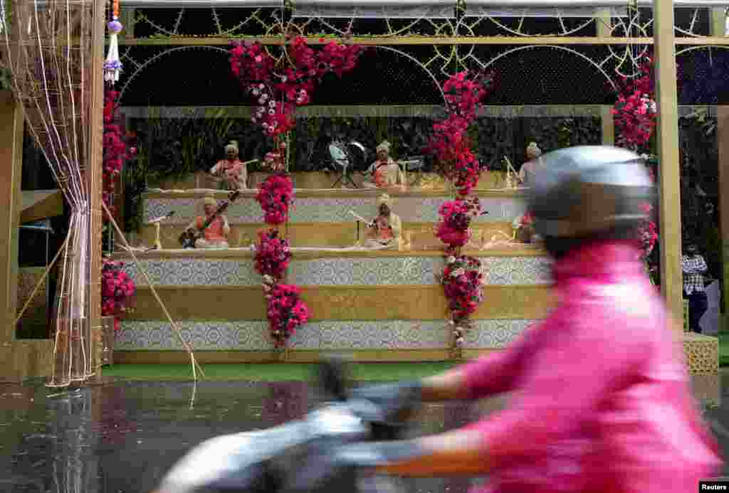 Folk musicians perform outside the home of Indian billionaire Mukesh Ambani on the day of the wedding of his son Anant Ambani in Mumbai, India.