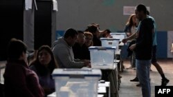 A man casts his vote during the referendum for Chile's new constitution proposal, in Santiago, Dec. 17, 2023. Analysts say the new proposal is even more conservative than the existing charter.