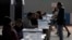 A man casts his vote during the referendum for Chile's new constitution proposal, in Santiago, Dec. 17, 2023. Analysts say the new proposal is even more conservative than the existing charter.