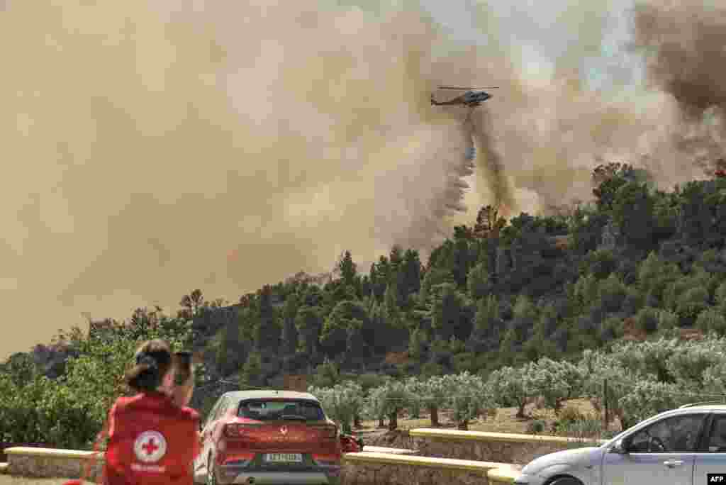 A fire-fighting helicopter drops water over a wild fire near Prodromos, 100km northeast from Athens.