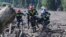 Rescue workers carry the body of a victim of a landslide, near Shovi, about 140 kilometers (85 miles) northwest of the capital Tbilisi, Georgia, Aug. 4, 2023. 