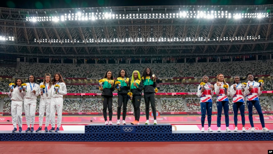 Gold medalist team Jamaica, center, stands with silver medalist United States, left, and bronze medalist Britain during the medal ceremony for the women's 4 x 100-meter relay at the 2020 Summer Olympics, Aug. 7, 2021, in Tokyo.