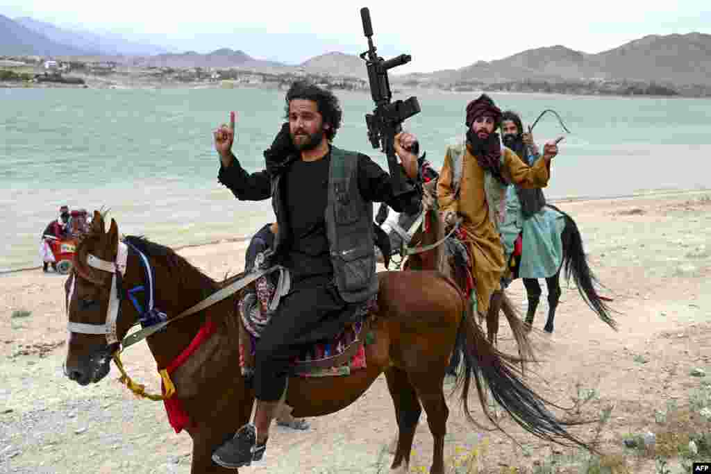 Taliban security forces ride horses along the Qargha Lake on the outskirts of Kabul.