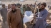 Afghan people carry the body of a relative killed in an earthquake at a burial site after an earthquake in the Herat province of Afghanistan, Oct. 9, 2023. Saturday's deadly earthquake killed and injured thousands.