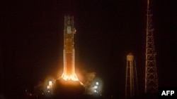 FILE — The Artemis I unmanned lunar rocket lifts off from launch pad 39B at NASA's Kennedy Space Center in Cape Canaveral, Florida, Nov. 16, 2022. The U.S. is delaying returning astronauts to the surface of the moon from 2025 to 2026, NASA said Tuesday. 