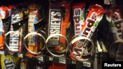 FILE -- A row of candy bars manufactured by Hershey is seen in a vending machine in Washington.