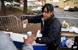 Yesenia Montero sells home-cooked Venezuelan-style food to fellow Venezuelan migrants sheltering at a motel designated for migrants in Denver, Colorado, April 18, 2024.