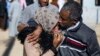 FILE - A man, suspected of having collaborated with the Islamic State (IS) group, is greeted by a relative upon being released from the Kurdish-run Alaya prison in the northeastern Syrian city of Qamishli, following their release, Apr. 16, 2023. 