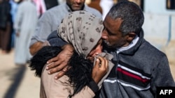 FILE - A man, suspected of having collaborated with the Islamic State (IS) group, is greeted by a relative upon being released from the Kurdish-run Alaya prison in the northeastern Syrian city of Qamishli, following their release, Apr. 16, 2023. 