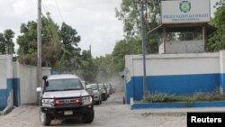 FILE - A convoy of cars carrying members of a Kenyan delegation leave the premises of Haitian National Police after meeting with Frantz Elbe, chief of the Haitian National Police, in Port-au-Prince, Haiti, Aug. 21, 2023. 