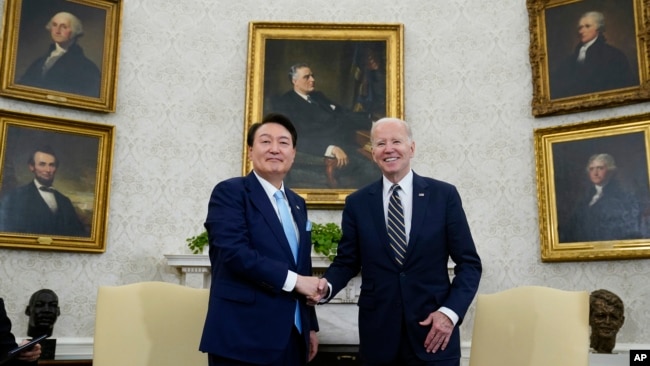 FILE - President Joe Biden shakes hands with South Korea's President Yoon Suk Yeol as they meet in the Oval Office of the White House, April 26, 2023, in Washington.
