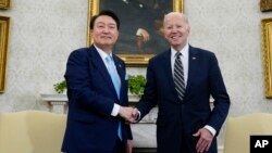 FILE - President Joe Biden shakes hands with South Korea's President Yoon Suk Yeol as they meet in the Oval Office of the White House in Washington, April 26, 2023.