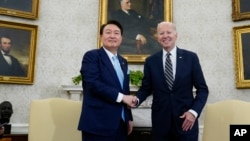 President Joe Biden shakes hands with South Korea's President Yoon Suk Yeol as they meet in the Oval Office of the White House, in Washington, April 26, 2023. 