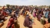 FILE - Sudanese refugees, who have fled the violence in their country, wait to receive food rations from World Food Program, near the border in Koufroun, Chad, May 9, 2023. 