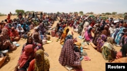 Sudanese refugees, who fled the violence in their country, wait to receive food assistance at a camp near the Sudan-Chad border, in Koufroun, Chad, May 9, 2023. 