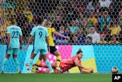 Australia's goalkeeper Mackenzie Arnold dives to make a save during the Women's World Cup third place playoff soccer match between Australia and Sweden in Brisbane, Australia, Aug. 19, 2023.