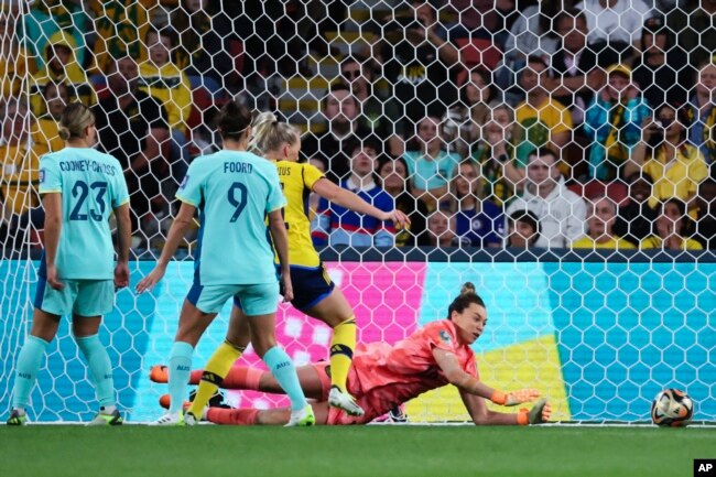 Australia's goalkeeper Mackenzie Arnold dives to make a save during the Women's World Cup third place playoff soccer match between Australia and Sweden in Brisbane, Australia, Aug. 19, 2023.