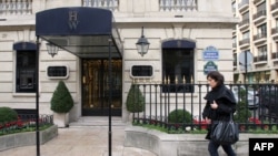 FILE - A woman walks in front of the ultra-luxury jewelry house Harry Winston on Dec. 5, 2008, in Paris, a day after three armed men snatched almost a total of displayed jewels. Harry Winston was just robbed again, the Paris prosecutor's office said on Sunday.