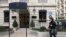 FILE - A woman walks in front of the ultra-luxury jewelry house Harry Winston on Dec. 5, 2008, in Paris, a day after three armed men snatched almost a total of displayed jewels. Harry Winston was just robbed again, the Paris prosecutor's office said on Sunday.