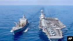 The USS Gerald R. Ford aircraft carrier refuels from the underway replenishment oiler USNS Laramie in the eastern Mediterranean Sea, Oct. 11, 2023. (U.S. Navy photo via AP)