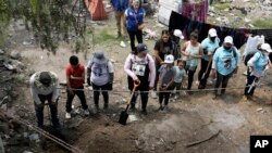 Relatives search for their missing loved ones in a clandestine grave in Zumpango, Mexico, April 19, 2024. 