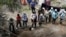 Relatives search for their missing loved ones in a clandestine grave in Zumpango, Mexico, April 19, 2024. 