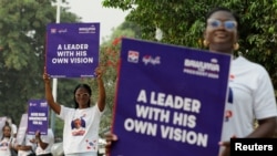 FILE - Supporters display placards during the campaign launch event of Ghana's Vice President and presidential candidate from the ruling New Patriotic Party (NPP), Dr. Mahamudu Bawumia ahead of the 2024 presidential election in Accra, Feb. 7, 2024.