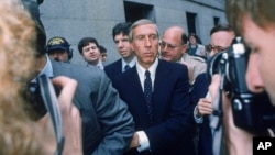 FILE - Ivan F. Boesky, center, leaves federal court in New York, April 24, 1987, after pleading guilty to violating federal securities laws. Boesky, the flamboyant Wall Street stock speculator, has died at the age of 87.