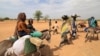 The United Nations refugee agency said Friday that 200,000 people have fled the violence in Sudan, including these families walking through the desert after crossing the border between Sudan and Chad to seek refuge in Goungour, Chad, May 12, 2023.